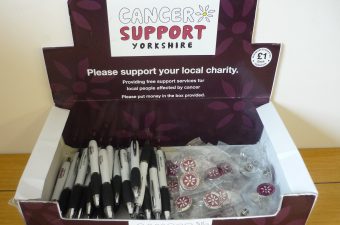 Cancer Support Yorkshire Merchandise Box containing pens and badges