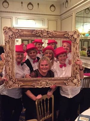 A group posing in costume for the Pink Lunch Fundraiser